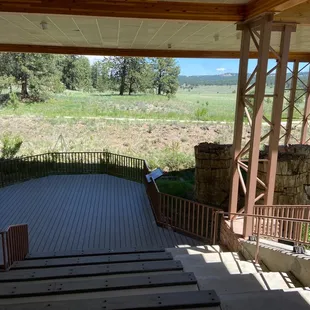 Amphitheater at the visitors center with three of many petrified tree stumps millions of years old.