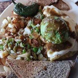 Veggie omelet with home style potatoes toast bells and onions with avocado and afire jalapeño. My favorite breakfast