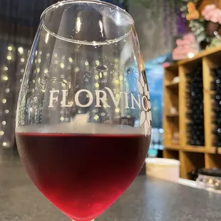 A lovely glass of "Glory wine," bar seating, wine stored in stock