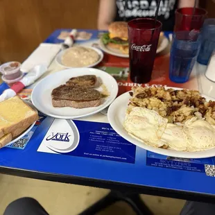 Top sirloin, 3 eggs, hash browns, white toast and biscuits and gravy.