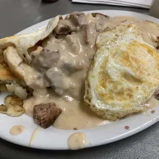 Biscuits and gravy SOS style, hash browns, and fried eggs.