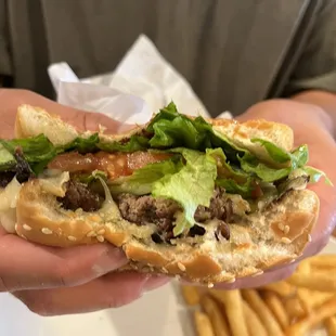 a hand holding a sandwich