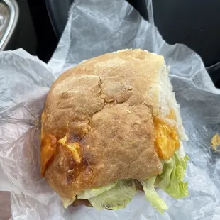 Biscuit with cheese, lettuce, bacon, and chicken