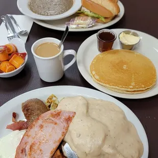 Paul's Platter is amazing comes with 3 eggs, bacon, sausage, ham, and biscuits and gravy served on top of crispy hash browns. Pancakes!