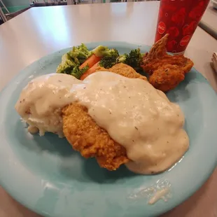 Chicken fried chicken plate and a wing from the fried chicken.