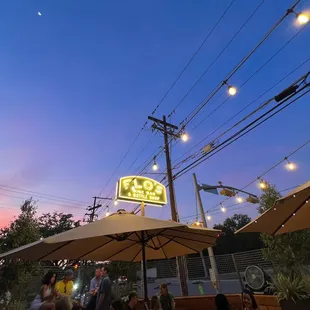 people sitting under umbrellas