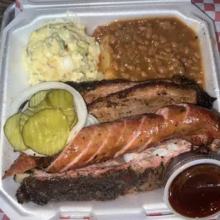 3 meat plate with baked beans and potato salad