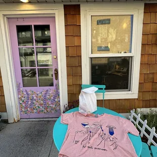 a t - shirt on a table outside a house