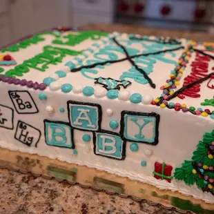 Periodic elements, baby blocks, and Christmas tree with presents on a custom cake.