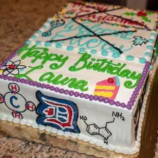 Custom triple event sheet cake with Duke logo and chemical symbols.
