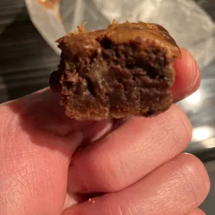 a hand holding a half eaten cookie