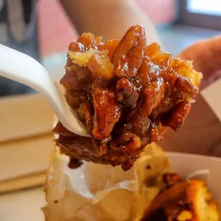 a person holding a spoon full of food