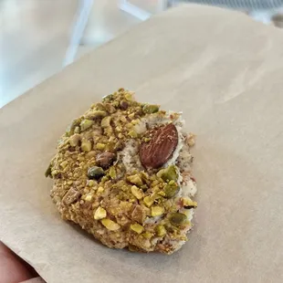 Partially eaten almond-pistachio macaron