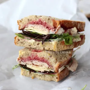 Smoked turkey sandwich ($10.50) - cherry + cranberry chutney, sage mayo, aged cheddar, mixed greens, multigrain)