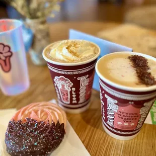 two cups of coffee and a doughnut