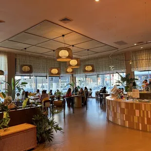people sitting at tables in a restaurant