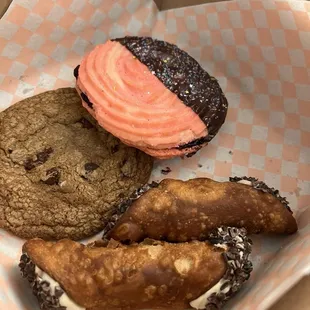 Chocolate chip cookie, butter cookie with jam filling, and two chocolate chip cannolis.