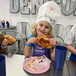 Decorating her chef hat and made pizza!