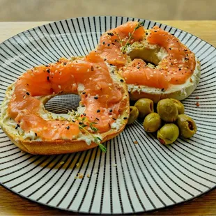 a bagel with salmon and olives