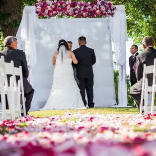 Our aisle was covered in rose petals in a beautiful design. And a floral beam for our arch