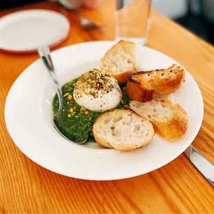 a plate of food with bread and a glass of water