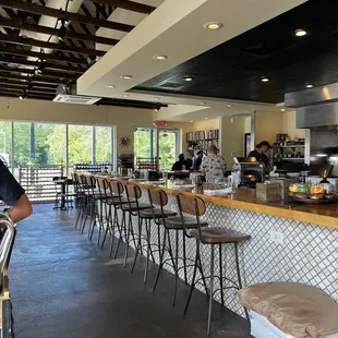 a man standing at a counter in a restaurant