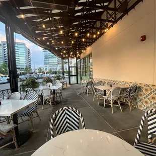 a view of a patio with tables and chairs