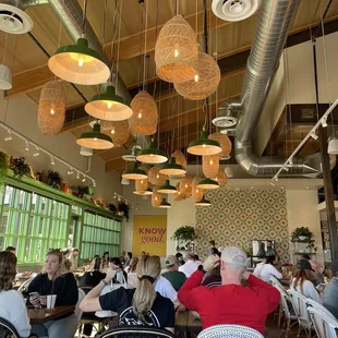 people sitting at tables in a restaurant