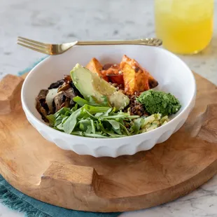 a bowl of food on a cutting board