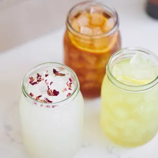 three jars of flowers on a table