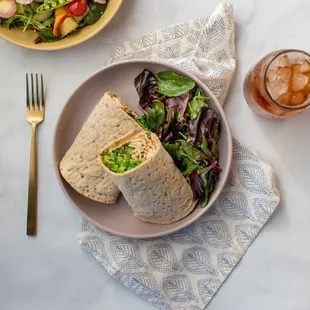 a plate of salad and a burrito