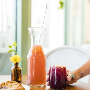  a woman holding a glass of juice