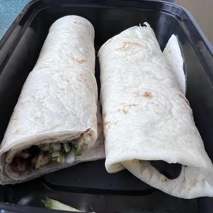 two burritos in a container