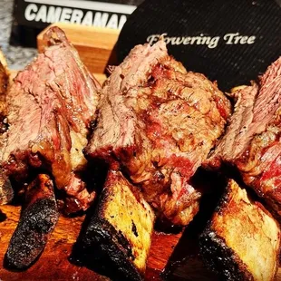 Savage and fantastically delish BBQ short ribs  created on a rustic grill - experience the magic of short rib BBQ heaven!