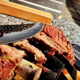 Savage and fantastically delish BBQ short ribs  created on a rustic grill - experience the magic of short rib BBQ heaven!
