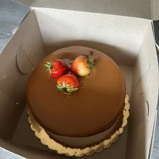 a chocolate cake with strawberries on top