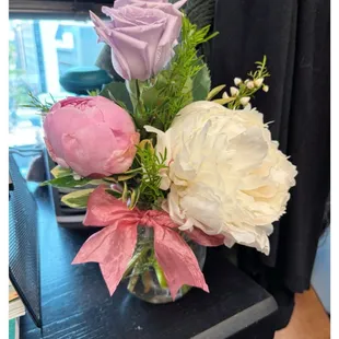 Peonies and roses for Mother's Day.  The arrangement includes a dark pink peony on the other side.