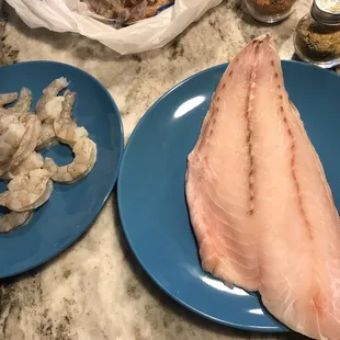 two plates of fish and shrimp