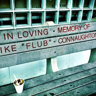 a cup of coffee on a bench