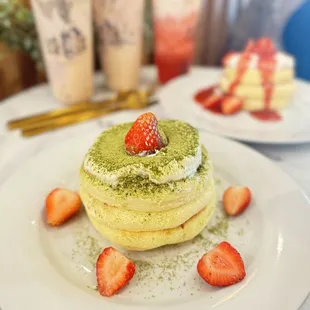 a stack of pancakes with strawberries