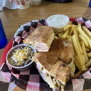 This is a Cuban sandwich with a side of beans and fries