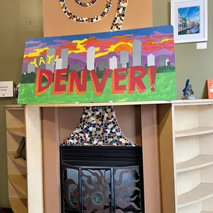 a fire place with a sign that says denver