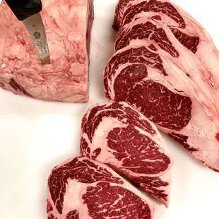 a piece of beef being sliced with a knife