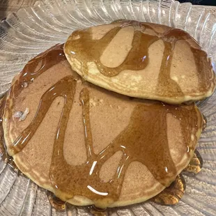 two pancakes covered in syrup