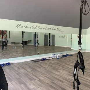 The front wall with mirrors, a cute Peter Pan quote, and a glimpse of the harnesses.