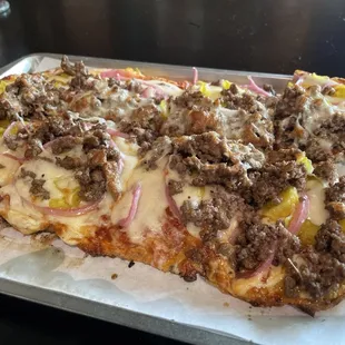 Hamburger pizza... black angus beef, peperchinies, and pickled onions.