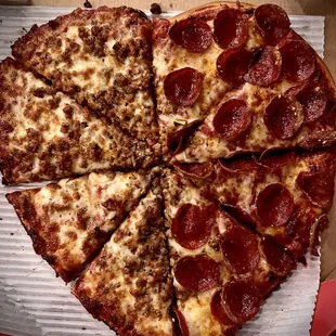 Valentine&apos;s Day pizza is shaped in heart half sausage, half pepperoni