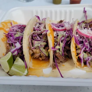 three tacos in a styrofoam container