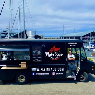 a man standing in front of a food truck