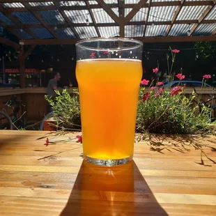 a glass of beer on a wooden table